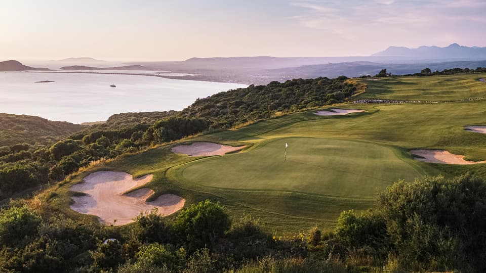 A green on the International Olympic Academy Golf Course above Navarino Bay at sunset