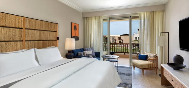 A Deluxe room at The Westin Resort, Costa Navarino, with a balcony over the gardens